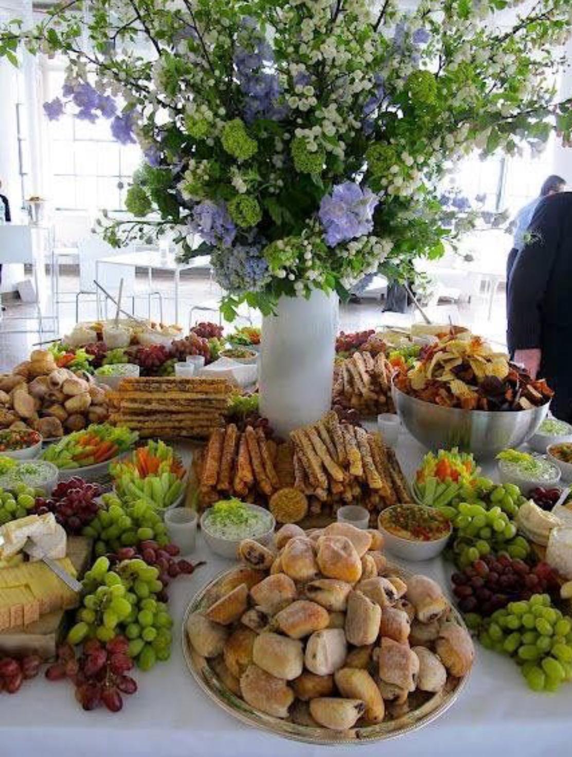 Family Style Catering grazing table with fresh fruit, cheese and flowers