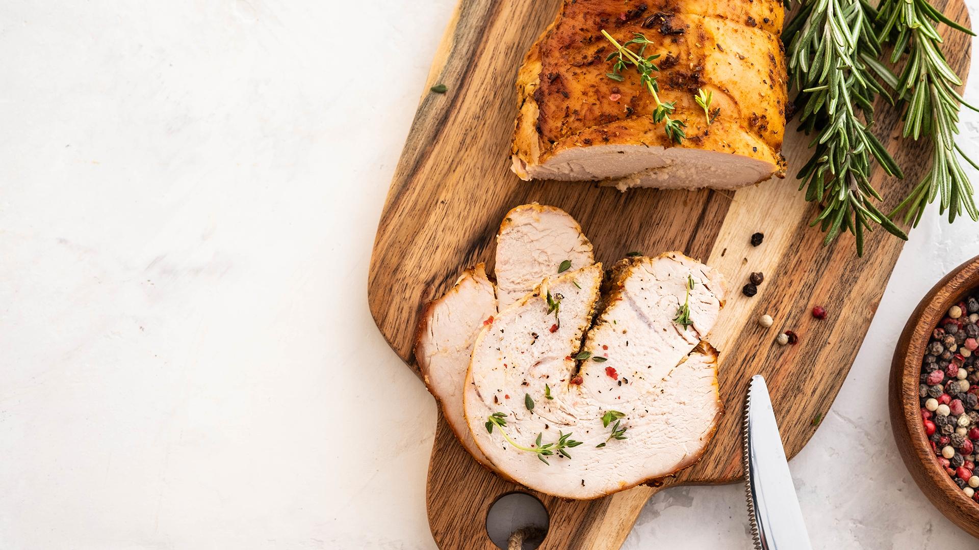 Sliced roast served on a wooden board